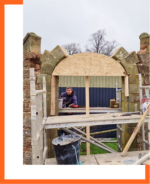Front view of a sandstone arch under construction