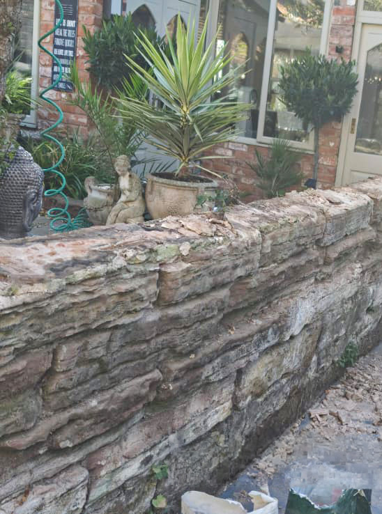 Side view of rebuilt sandstone wall